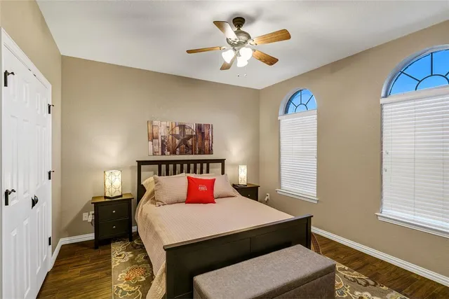 a bedroom with a bed a window and a chandelier