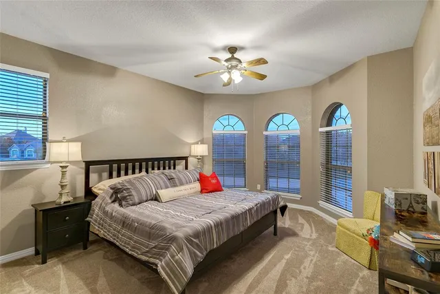 a bedroom with a large bed and a chandelier