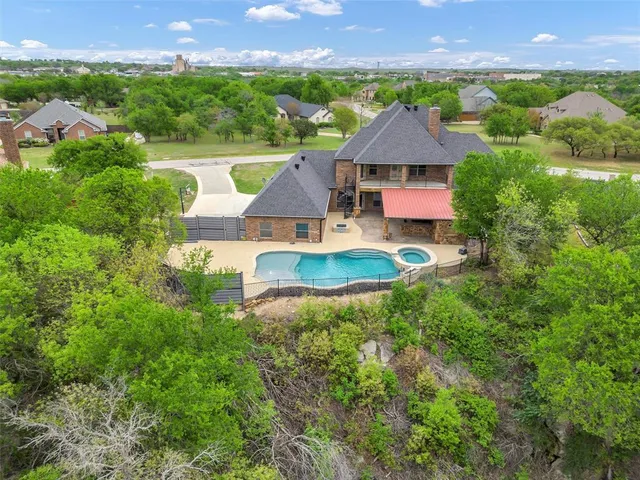 an aerial view of a house with outdoor space swimming pool and a patio