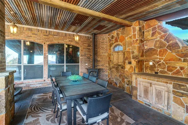 a view of a deck with table and chairs with wooden floor and floor to ceiling window