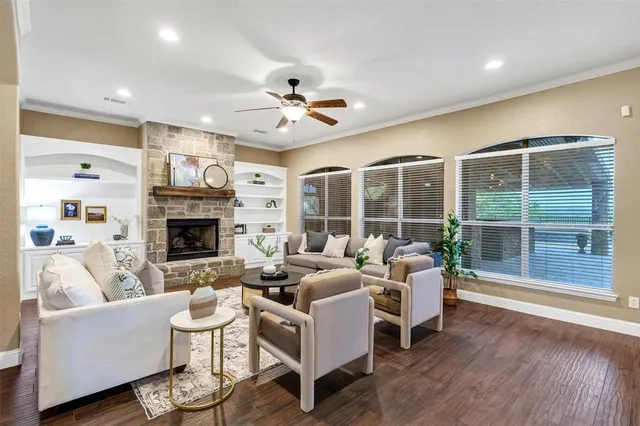 a living room with furniture a fireplace and a flat screen tv
