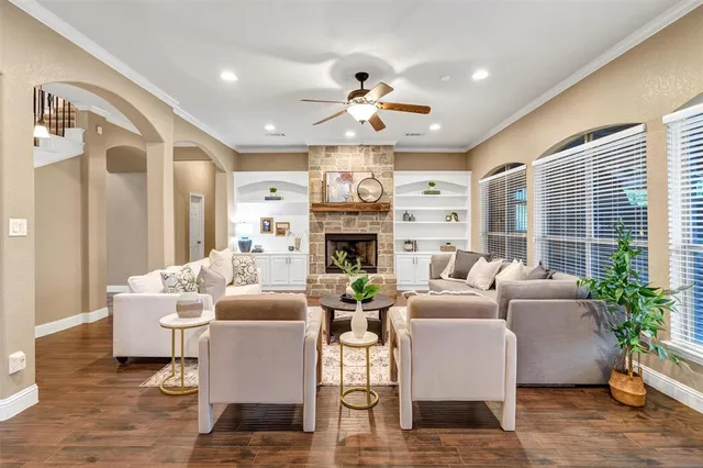 a living room with fireplace furniture and a large window