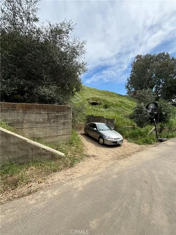 a view of a backyard with wooden fence