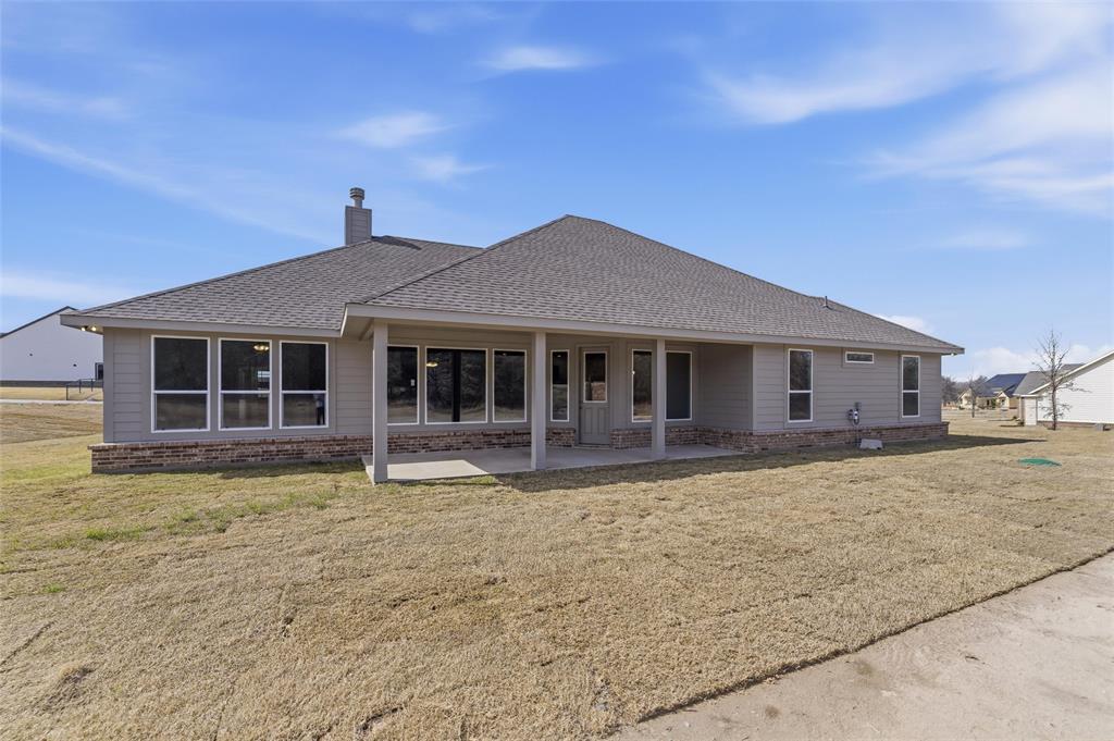 144 Oak Grv Way Springtown, TX 76082 - Photo 25 of 27 a house view with a garden space