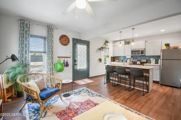 a living room with furniture and kitchen view