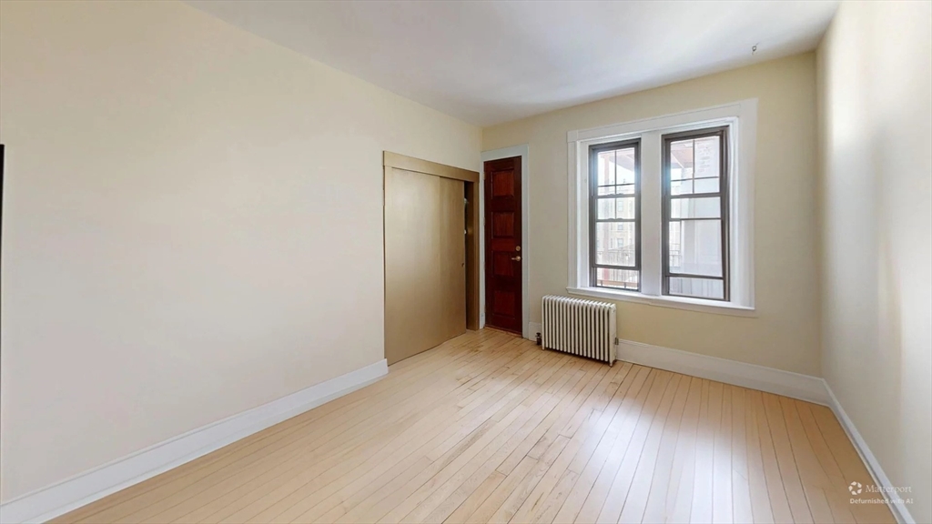 1161 Commonwealth Avenue, Unit 8 Boston, MA 02134 - Photo 11 of 17 an empty room with wooden floor and windows