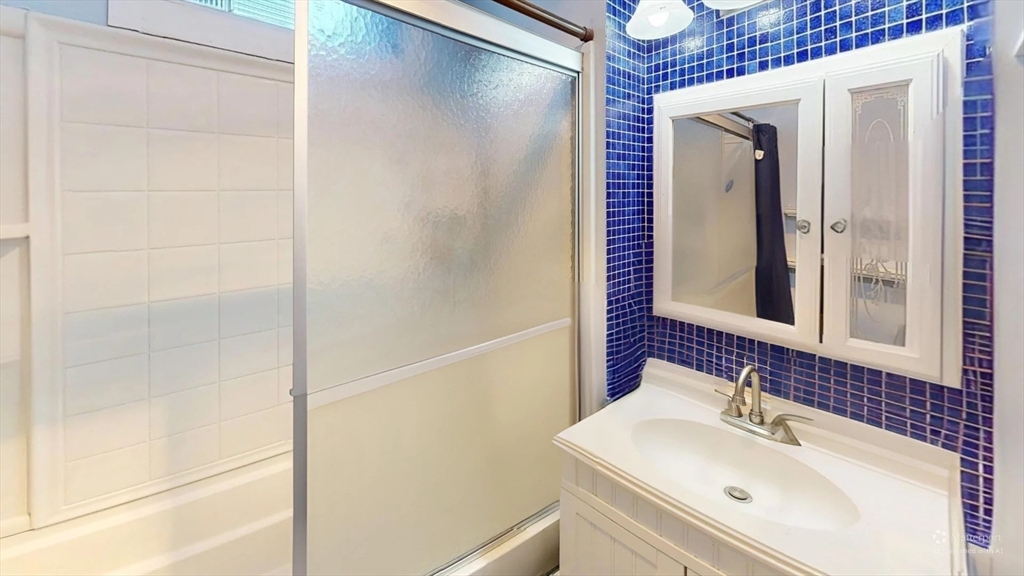 1161 Commonwealth Avenue, Unit 8 Boston, MA 02134 - Photo 15 of 17 a bathroom with a sink and mirror