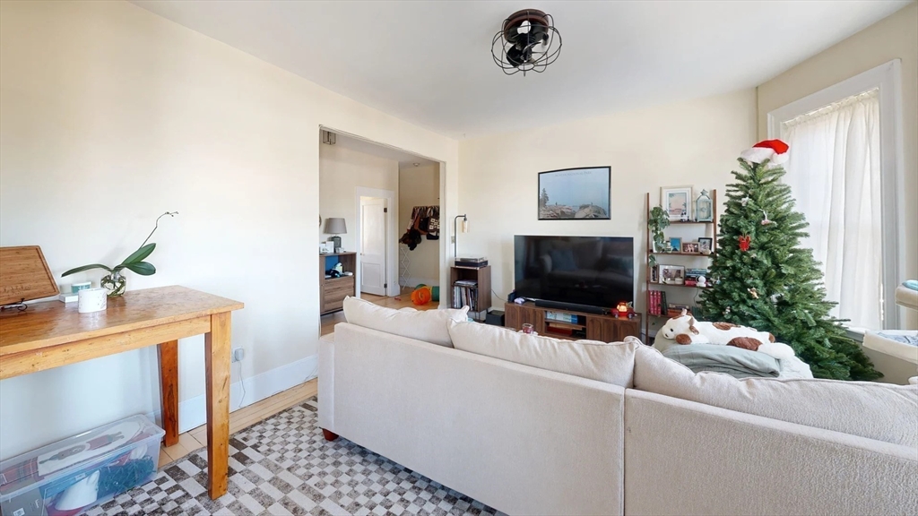 1161 Commonwealth Avenue, Unit 8 Boston, MA 02134 - Photo 4 of 17 a living room with furniture and a fireplace