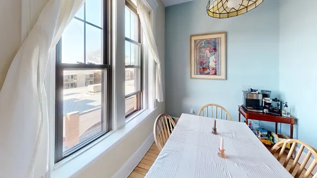 a balcony with wooden floor and furniture