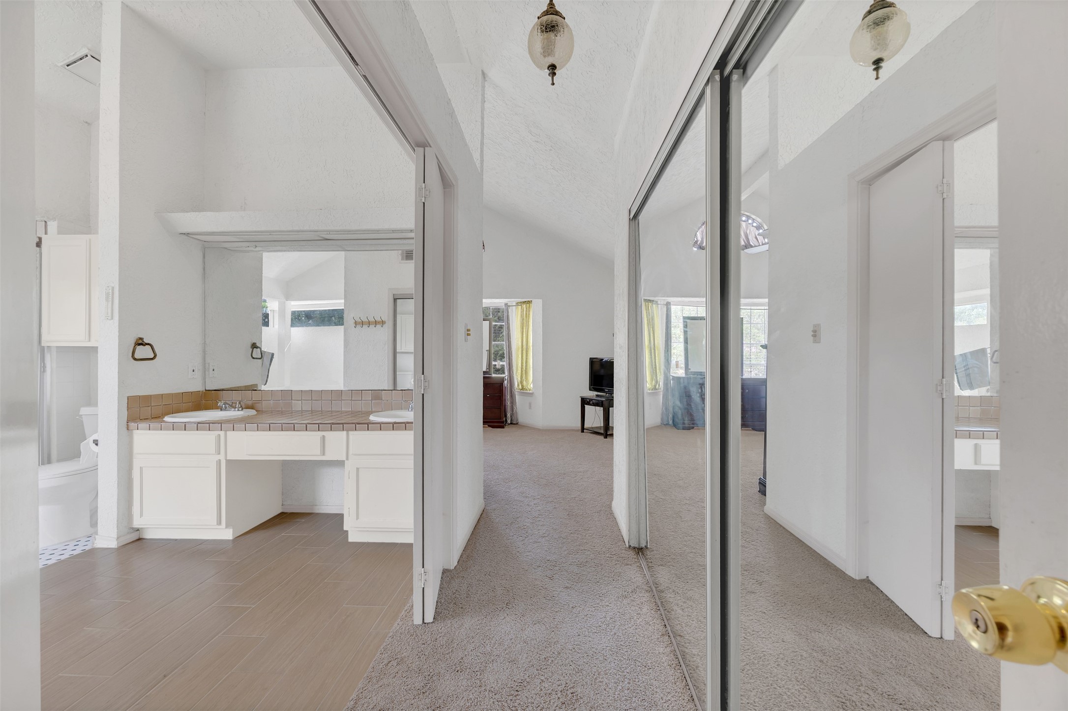 15619 Beechnut Street Houston, TX 77083 - Photo 21 of 29 Spacious primary suite entrance with dual mirrored closets and a bright, open layout.