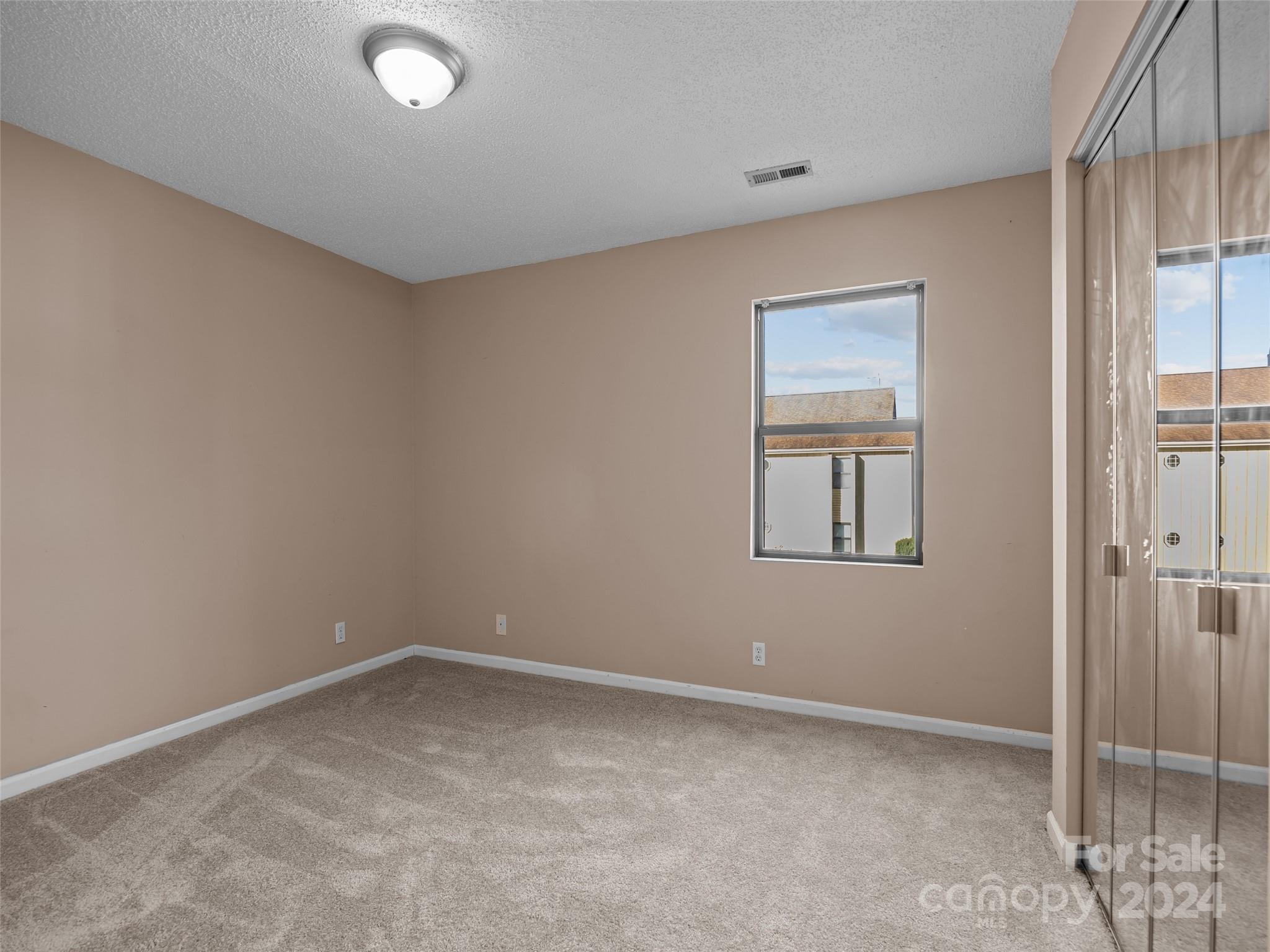 110 Heywood Road, Unit 14D Arden, NC 28704 - Photo 13 of 20 an empty room with windows