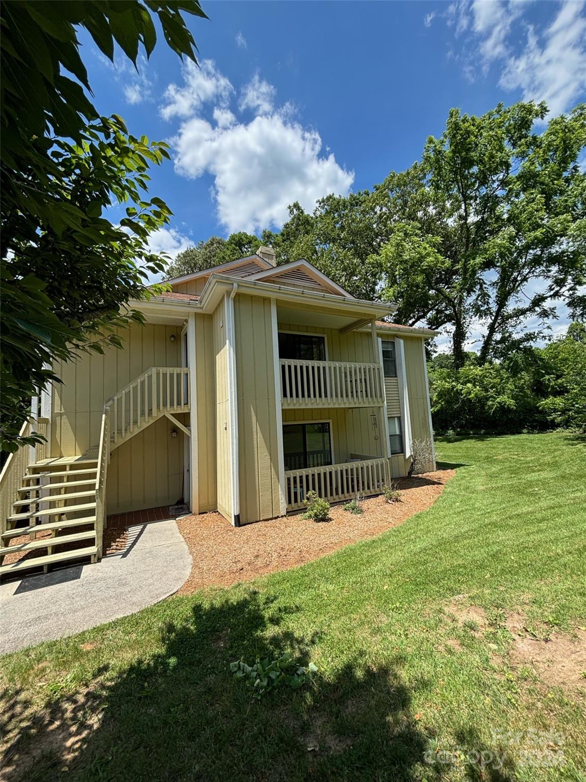 110 Heywood Road, Unit 14D Arden, NC 28704 - Photo 17 of 20 a view of a house with a yard
