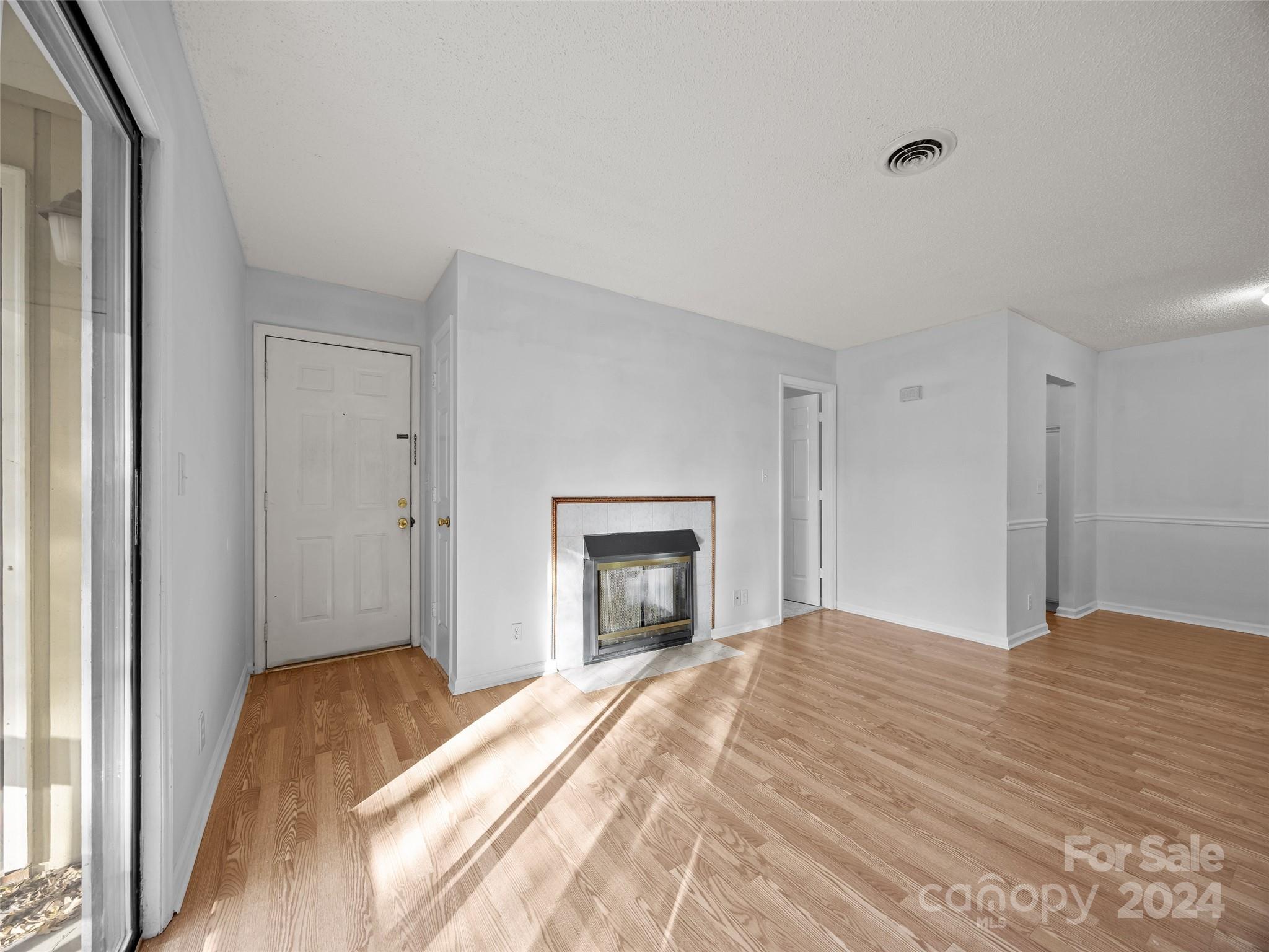 110 Heywood Road, Unit 14D Arden, NC 28704 - Photo 2 of 20 a bedroom with a bed and a fireplace