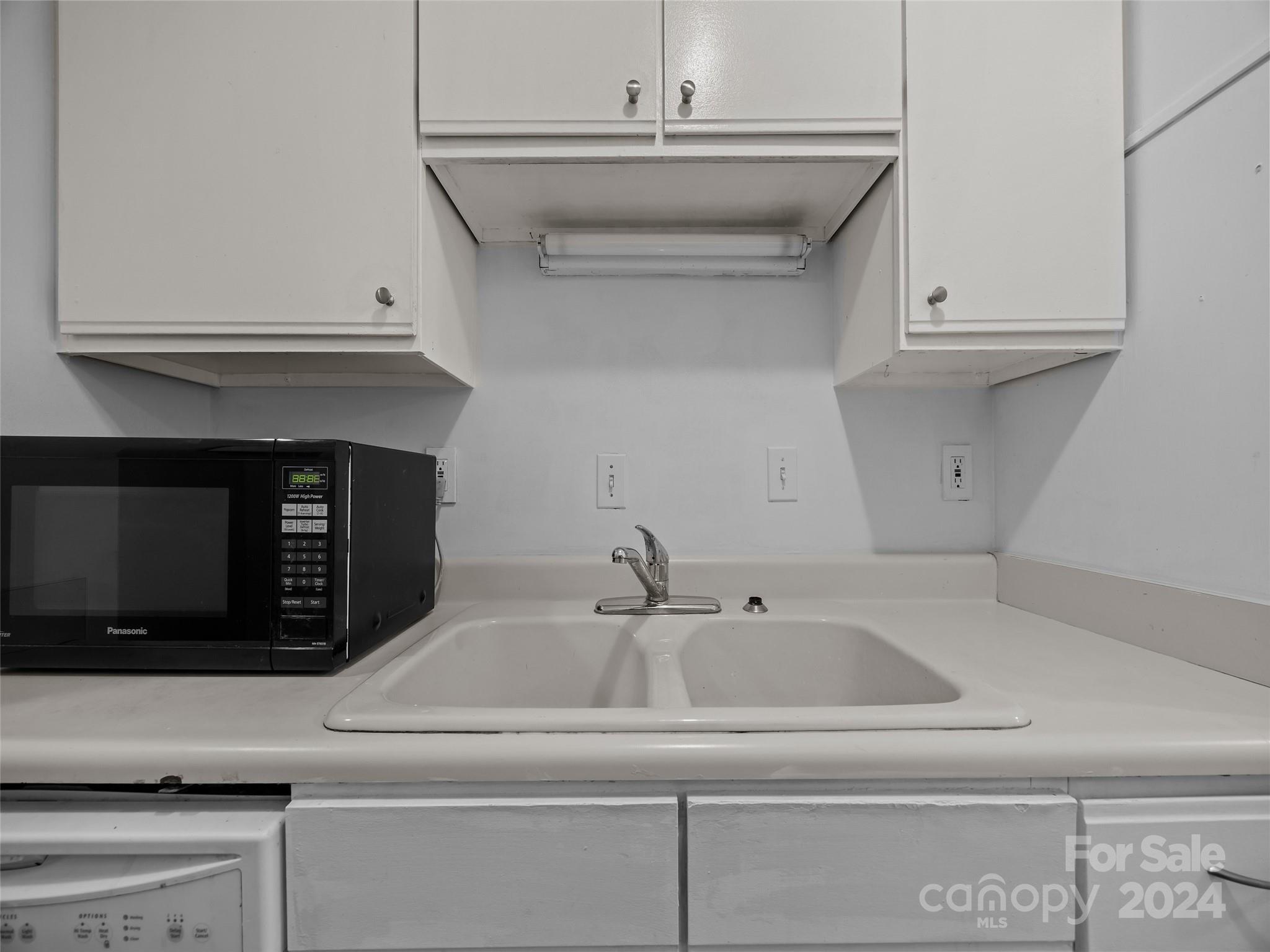110 Heywood Road, Unit 14D Arden, NC 28704 - Photo 6 of 20 a kitchen with a sink and cabinets