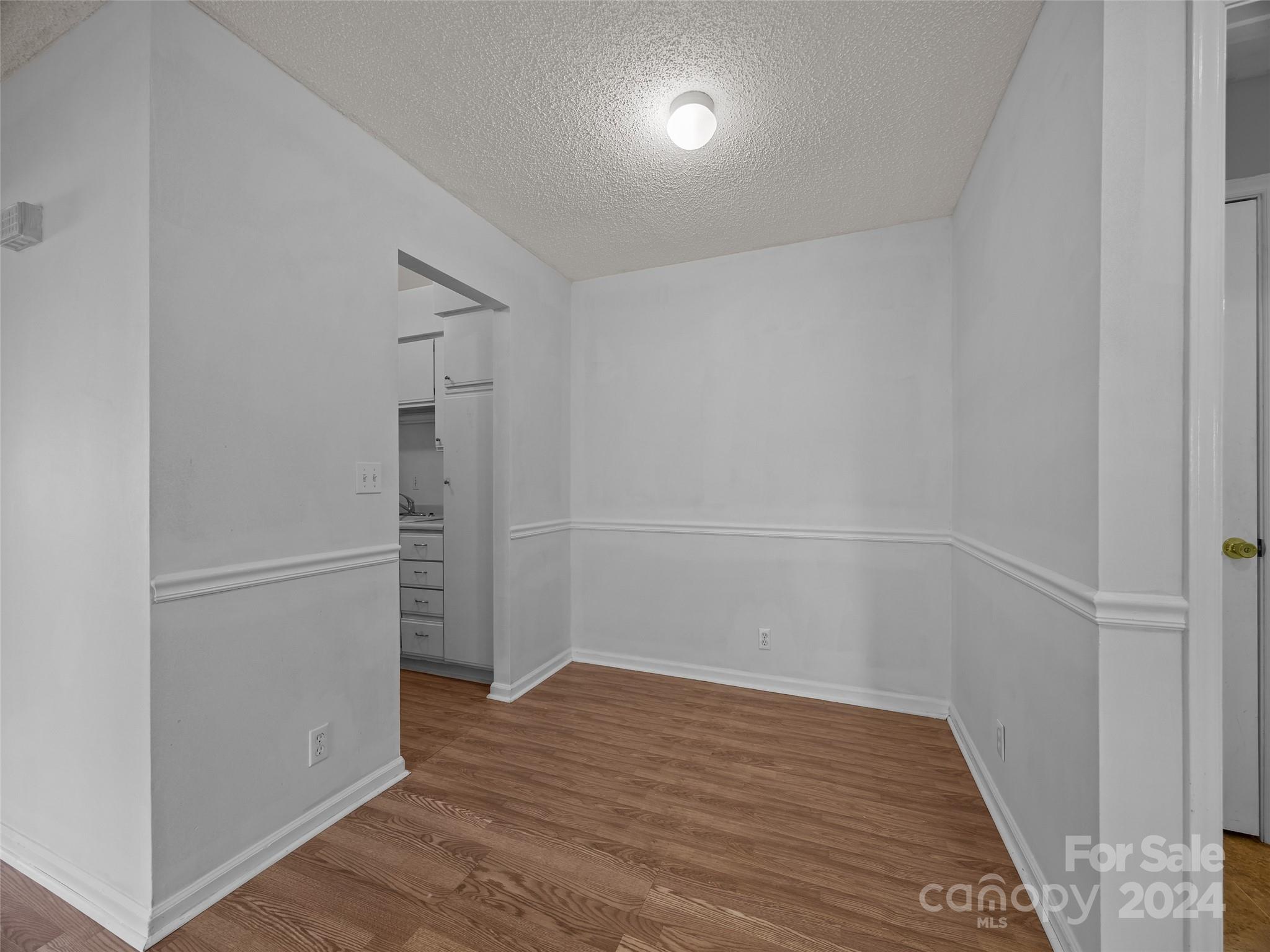 110 Heywood Road, Unit 14D Arden, NC 28704 - Photo 7 of 20 a view of empty room with wooden floor