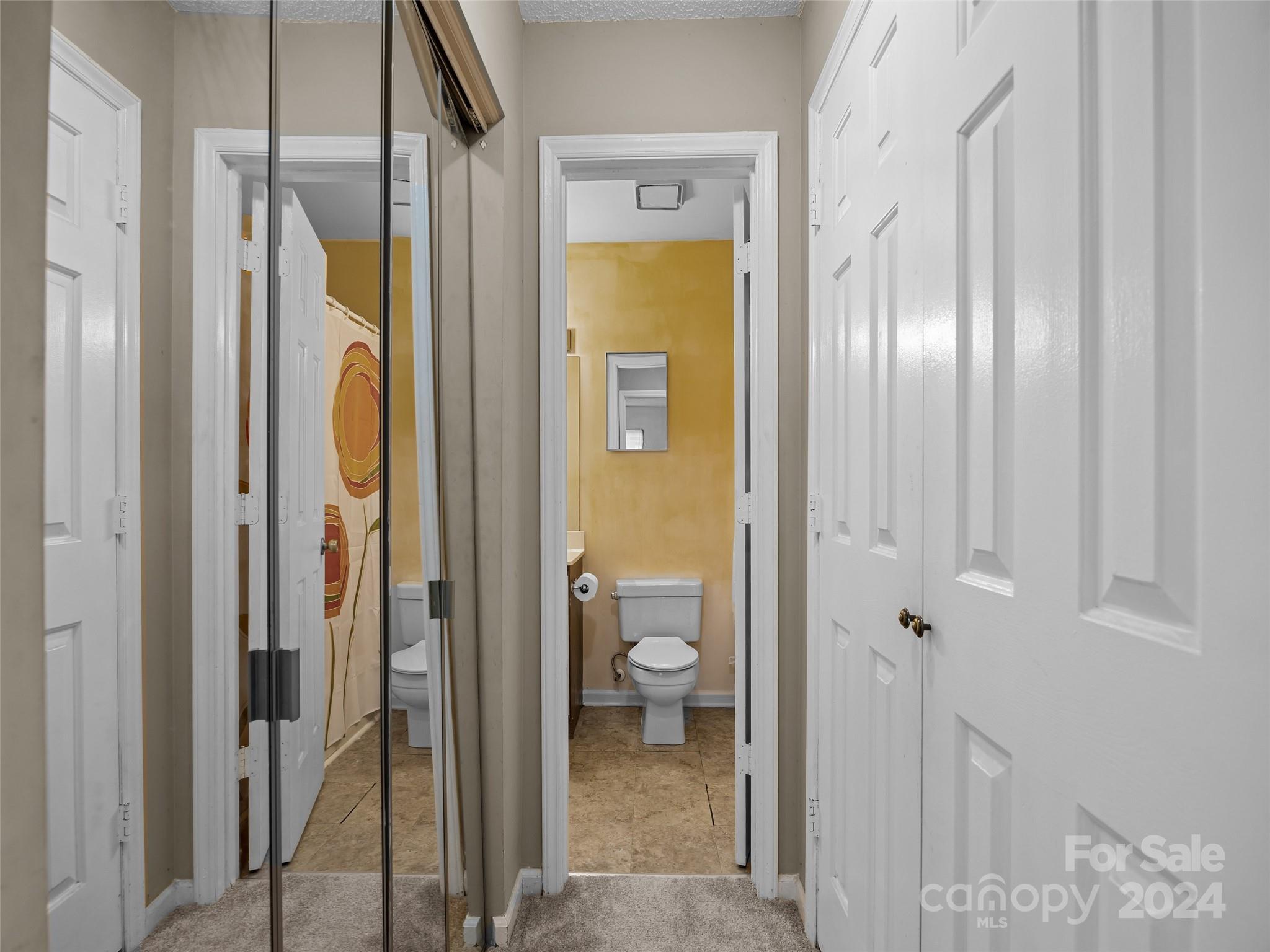 110 Heywood Road, Unit 14D Arden, NC 28704 - Photo 9 of 20 a bathroom with a glass shower door and a toilet