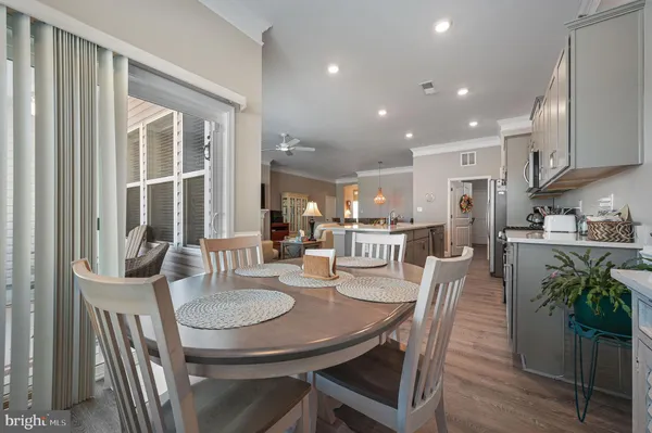 a dining room with furniture and a floor to ceiling window