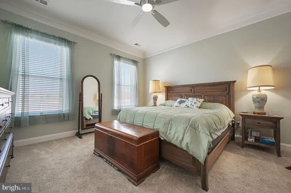a spacious bedroom with a bed and a chandelier
