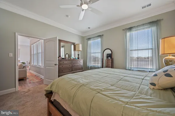 a bedroom with a bed and a large mirror