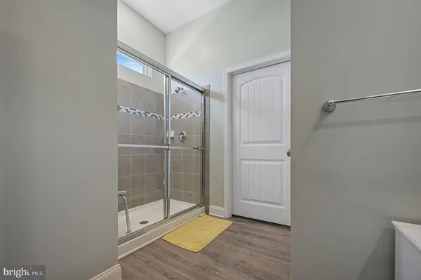 a bathroom with a glass shower door