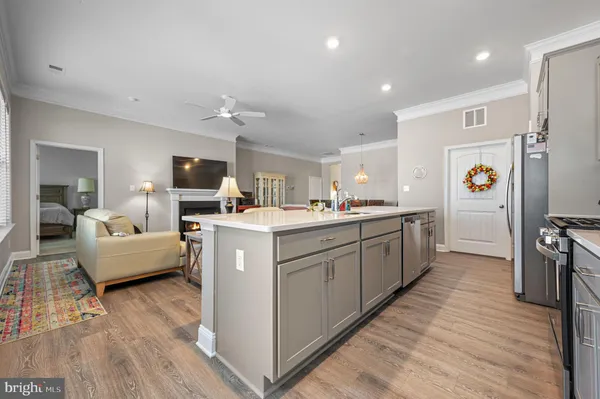 a kitchen that has a lot of cabinets a sink and appliances in it