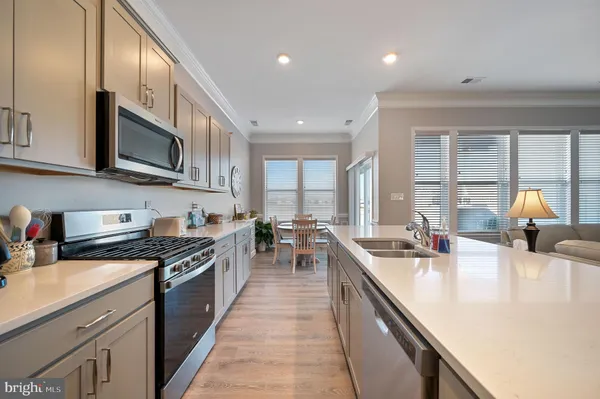 a kitchen with stainless steel appliances a stove sink microwave and cabinets