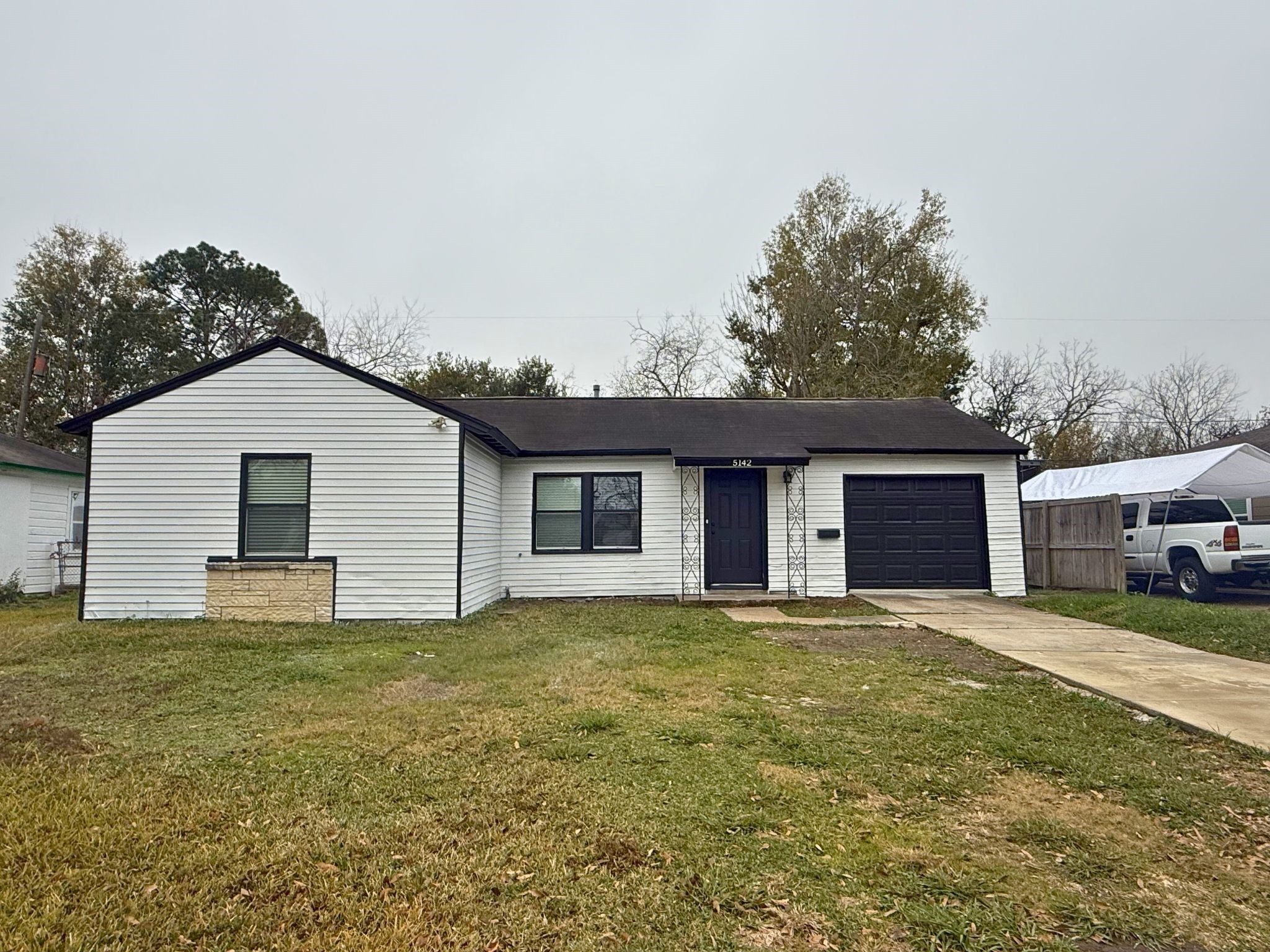 5142 Balkin Street Houston, TX 77021 - Photo 1 of 12 a house with trees in the background