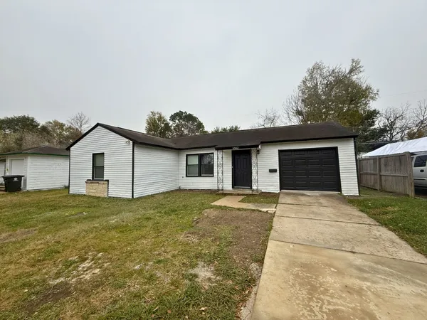 a view of a house with a yard and garage
