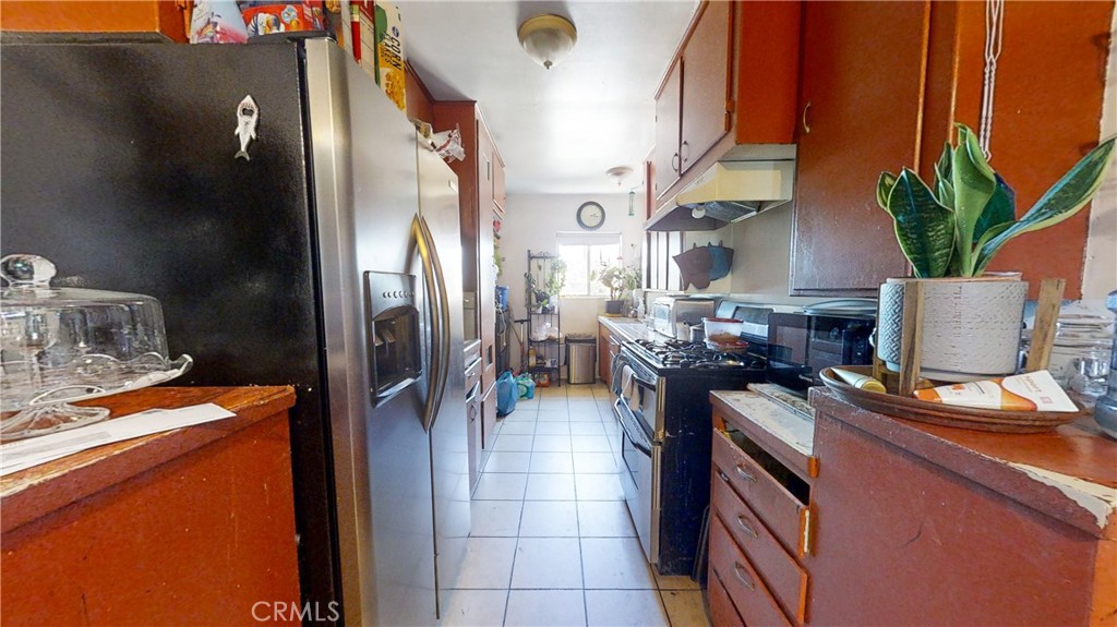 13226 Paxton Street Pacoima, CA 91331 - Photo 11 of 27 a kitchen with stainless steel appliances granite countertop a refrigerator a stove and a sink