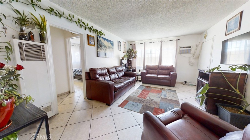 13226 Paxton Street Pacoima, CA 91331 - Photo 18 of 27 a living room with furniture and a flat screen tv