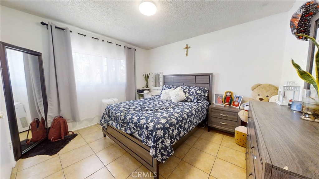 13226 Paxton Street Pacoima, CA 91331 - Photo 19 of 27 a bedroom with a bed and a dresser