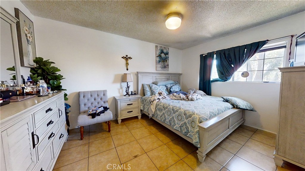 13226 Paxton Street Pacoima, CA 91331 - Photo 21 of 27 a bedroom with a bed and a dresser