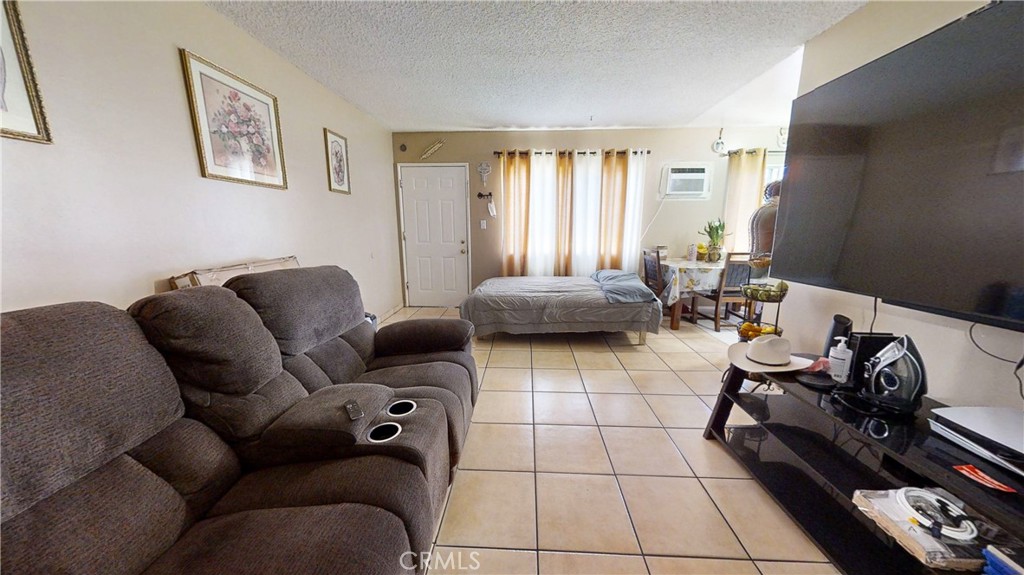 13226 Paxton Street Pacoima, CA 91331 - Photo 22 of 27 a living room with furniture and a window