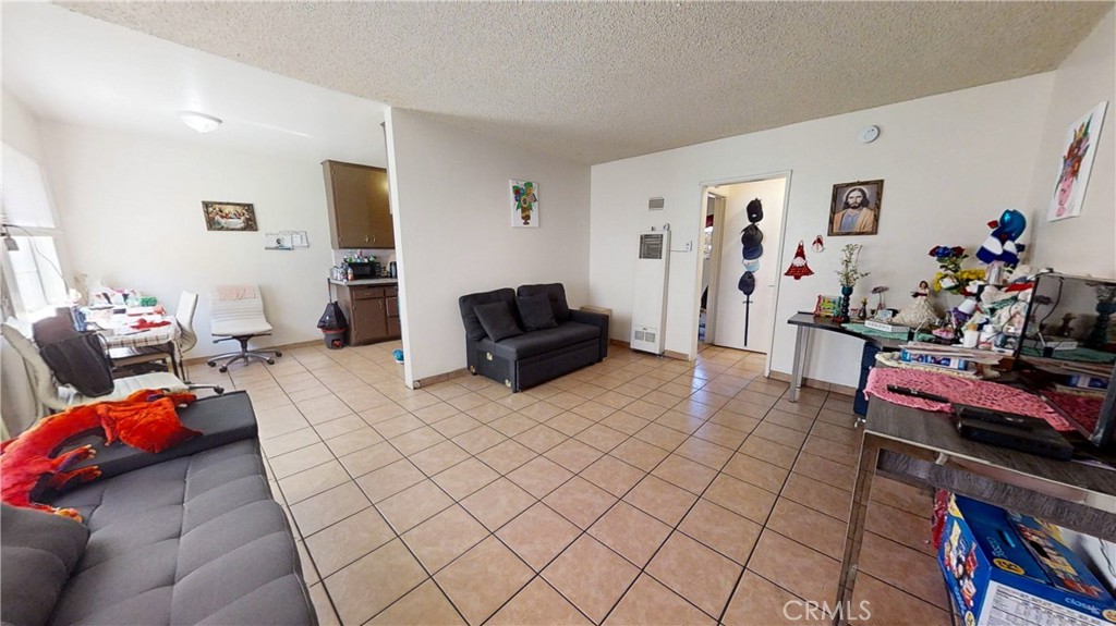 13226 Paxton Street Pacoima, CA 91331 - Photo 26 of 27 a living room with furniture and a flat screen tv