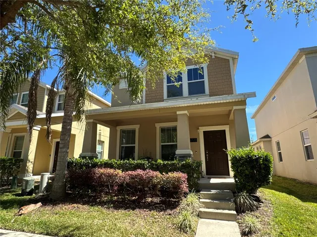 a front view of a house with yard and green space
