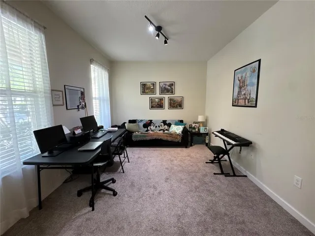 a living room with furniture a window and a flat screen tv