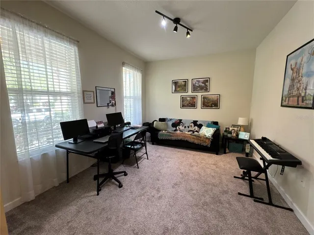 a kitchen with stainless steel appliances a refrigerator a stove a sink and chairs