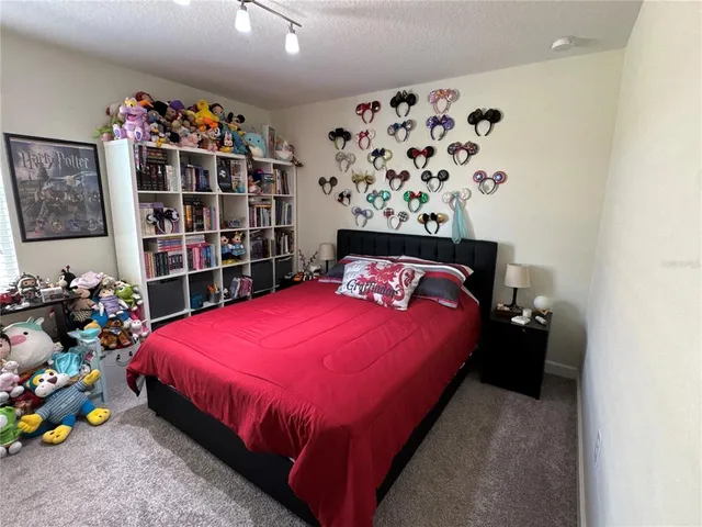 a bedroom with bed and a large mirror