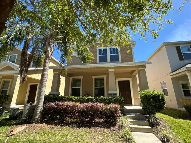 a front view of a house with yard and green space