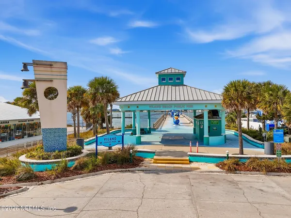 an aerial view of a house with a garden and lake view