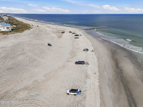 a front view of a house with garden and parking