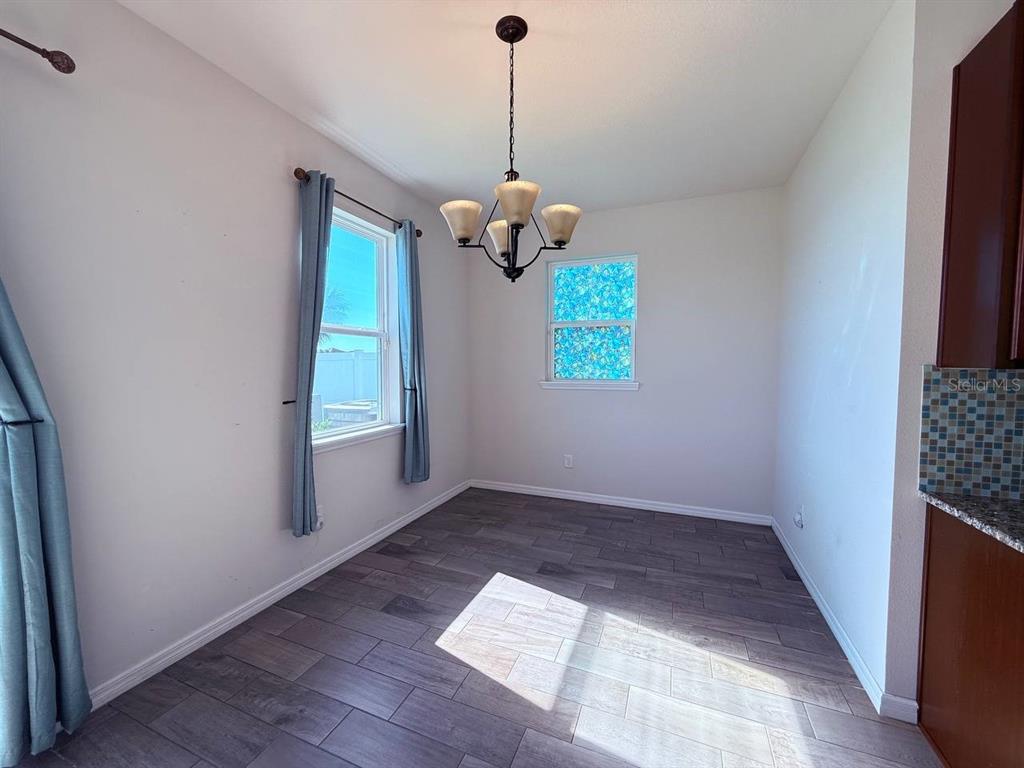 14112 Poke Ridge Drive Riverview, FL 33579 - Photo 25 of 32 an empty room with windows and ceiling fan
