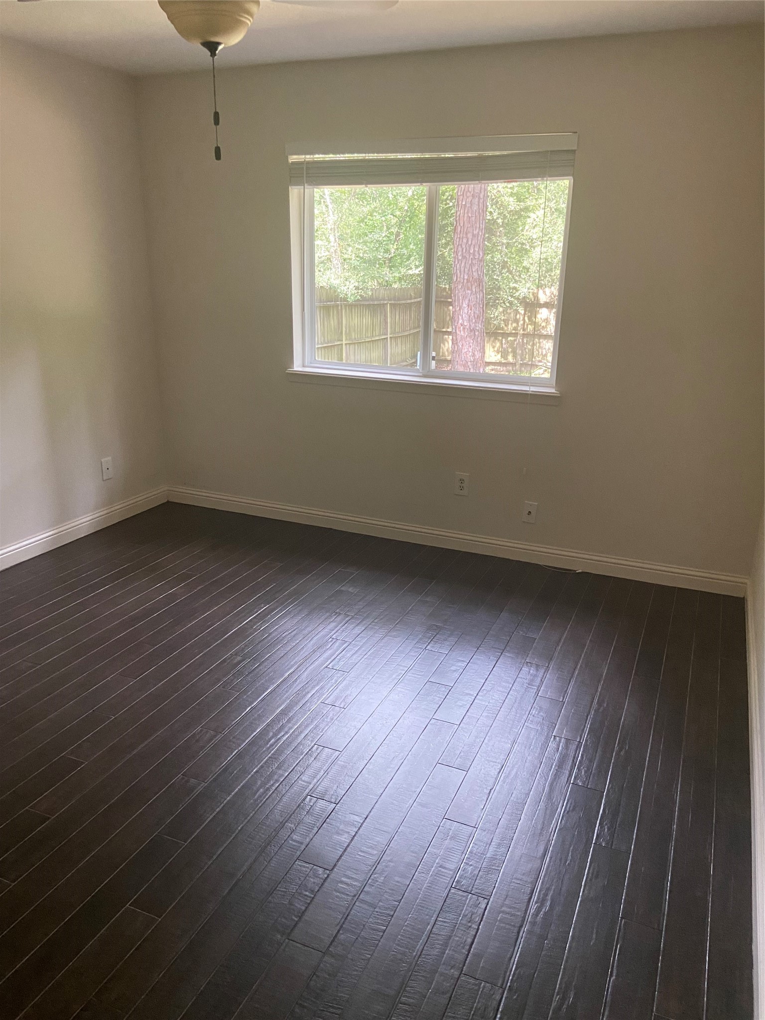 60 Oldstream Court Spring, TX 77381 - Photo 8 of 9 an empty room with wooden floor and windows