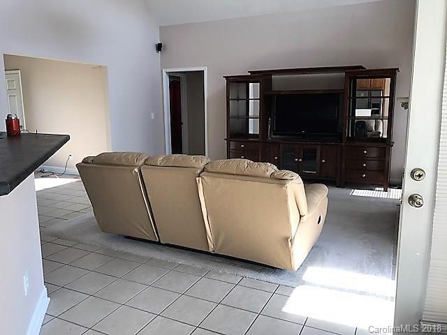 211 Trinity Church Road Monroe, NC 28112 - Photo 11 of 27 a living room with a couch and a flat screen tv