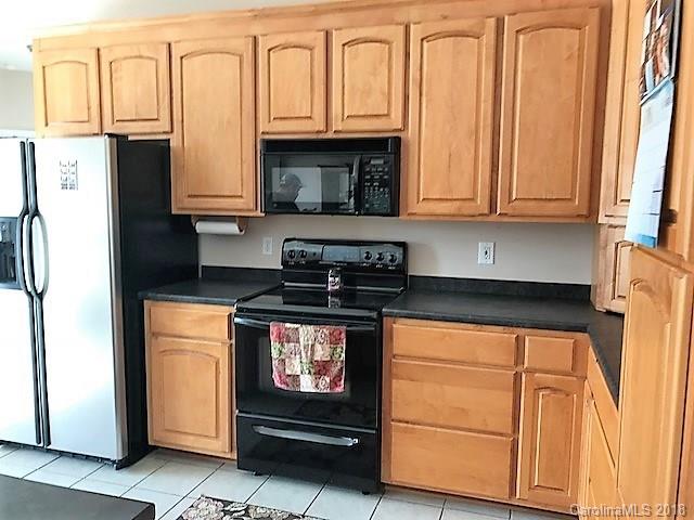 211 Trinity Church Road Monroe, NC 28112 - Photo 16 of 27 a kitchen with granite countertop white cabinets and stainless steel appliances