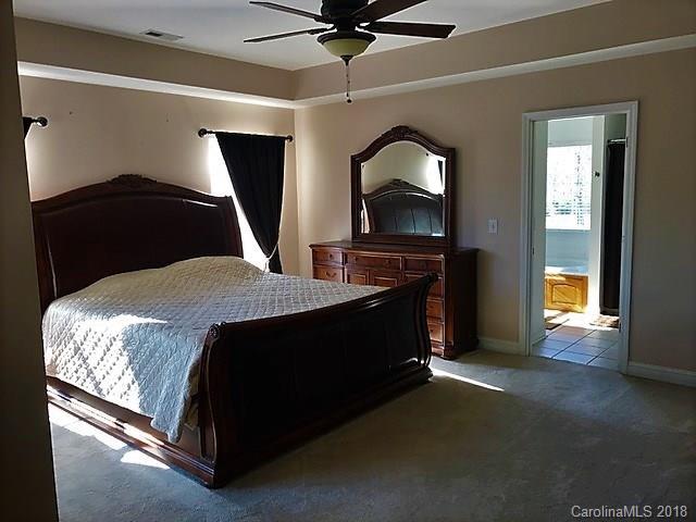 211 Trinity Church Road Monroe, NC 28112 - Photo 19 of 27 a bedroom with a bed and a fireplace