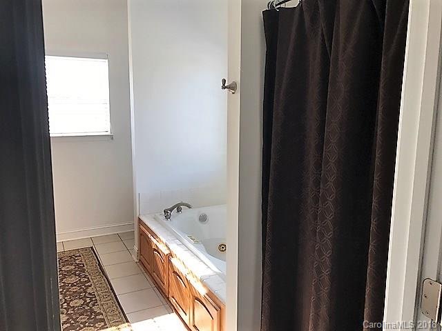 211 Trinity Church Road Monroe, NC 28112 - Photo 21 of 27 a bathroom with a bathtub and shower