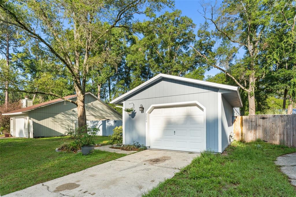 2026 Southwest 73rd Street Gainesville, FL 32607 - Photo 18 of 20 a front view of a house with garden