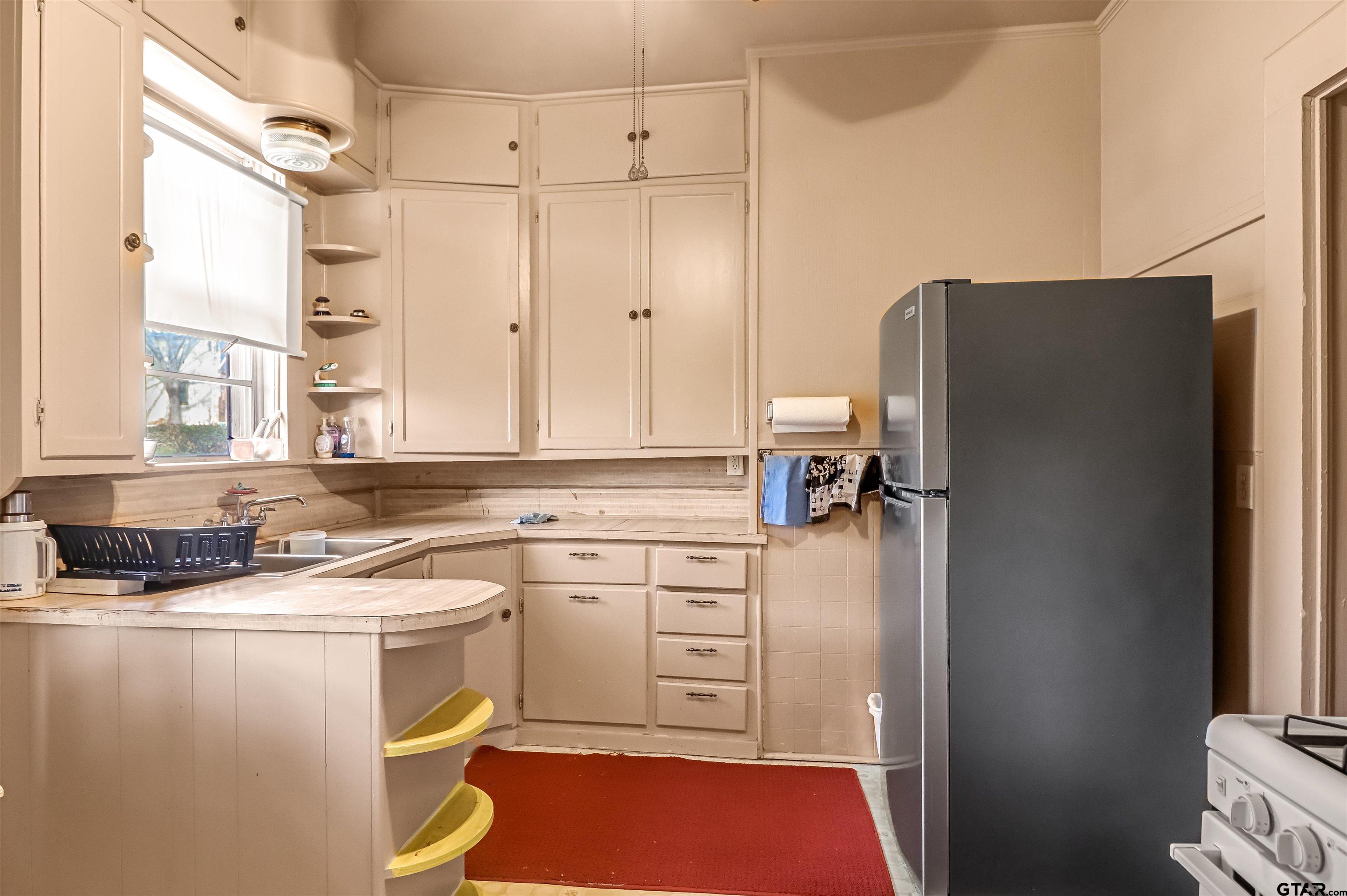 205 East 4th Street Rusk, TX 75785 - Photo 11 of 23 a kitchen with a refrigerator and a sink