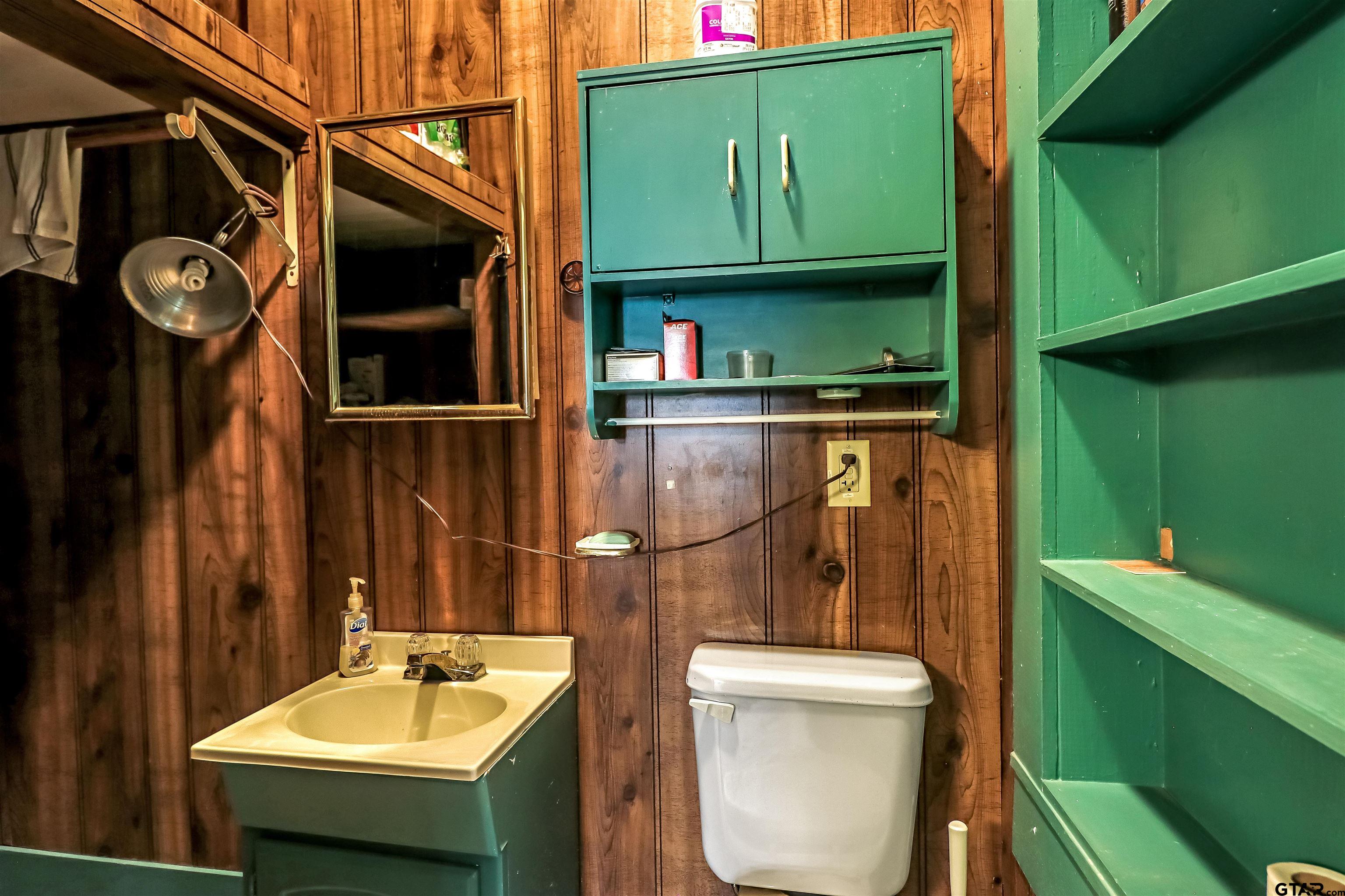 205 East 4th Street Rusk, TX 75785 - Photo 20 of 23 a bathroom with a sink a toilet and mirror